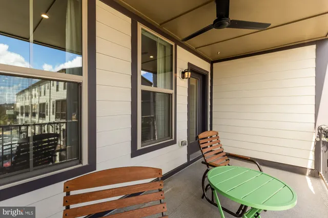 a balcony with furniture and a potted plant