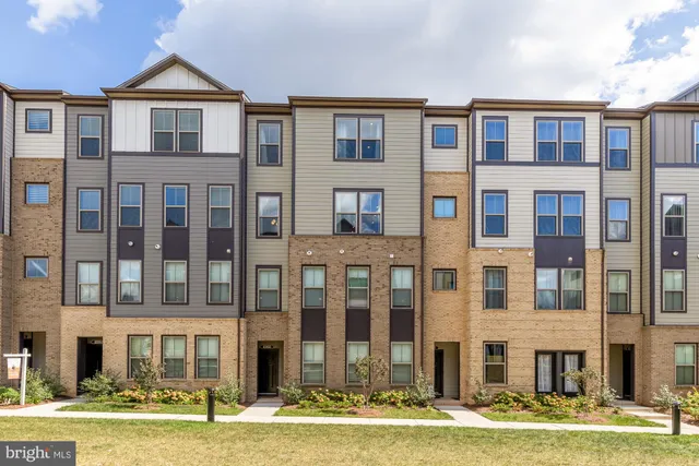 a front view of residential houses with yard
