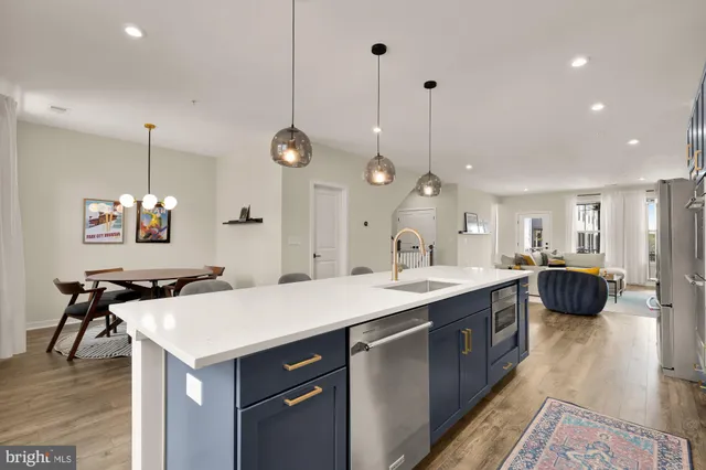 a large kitchen with kitchen island a sink appliances and a counter top space