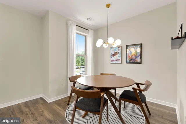 a dining room with furniture and chandelier