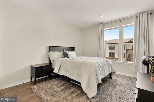 a bedroom with a bed and a night stand