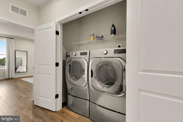 a bedroom with a large bed chandelier and a window
