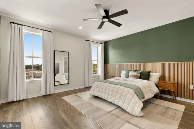 a bedroom with a bed a dresser and a window