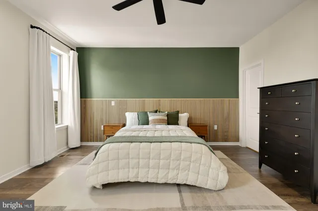 a bedroom with a large bed and a chandelier