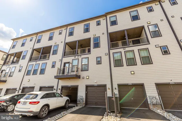 a view of a building with a garden and sitting area