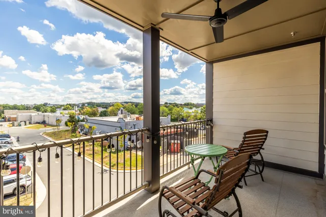 a view of a chairs and table in the balcony