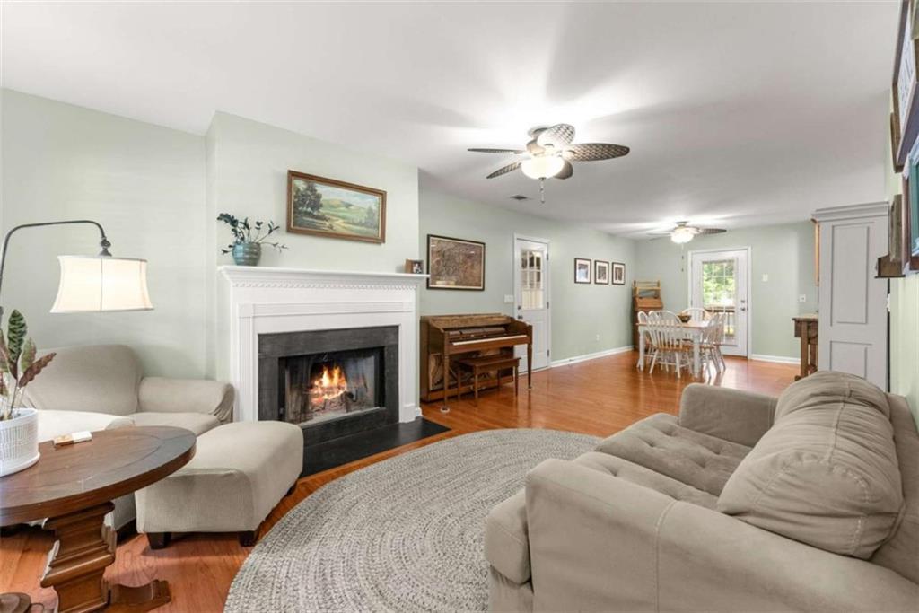 7210 Fields Drive Cumming, GA 30041 - Photo 11 of 58 a living room with furniture a fireplace and a chandelier