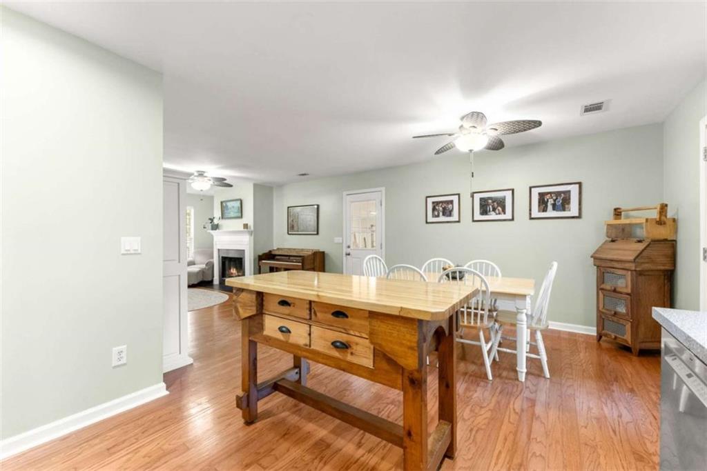 7210 Fields Drive Cumming, GA 30041 - Photo 21 of 58 a view of a dining room with furniture and wooden floor