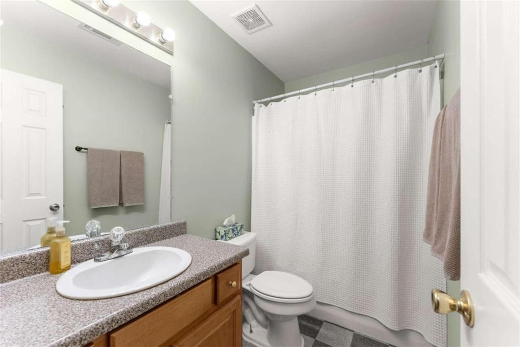 7210 Fields Drive Cumming, GA 30041 - Photo 26 of 58 a bathroom with a granite countertop sink and a mirror