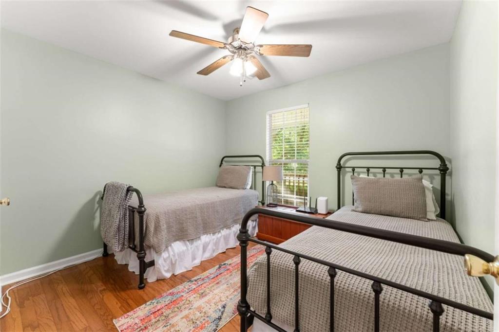 7210 Fields Drive Cumming, GA 30041 - Photo 27 of 58 a bedroom with a bed and a chair