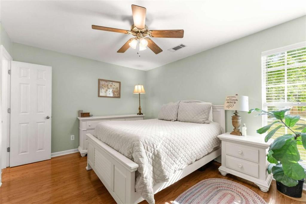 7210 Fields Drive Cumming, GA 30041 - Photo 29 of 58 a bedroom with a bed and a chandelier