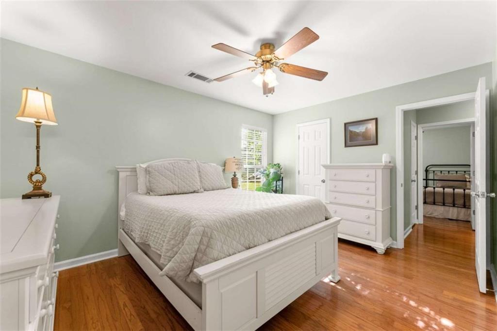 7210 Fields Drive Cumming, GA 30041 - Photo 30 of 58 a room with a bed and a chandelier