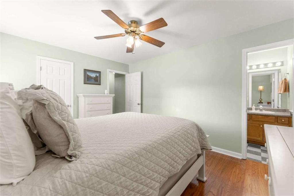 7210 Fields Drive Cumming, GA 30041 - Photo 31 of 58 a bedroom with a bed and a chandelier