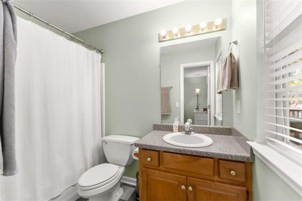 7210 Fields Drive Cumming, GA 30041 - Photo 32 of 58 a bathroom with a granite countertop sink toilet and mirror