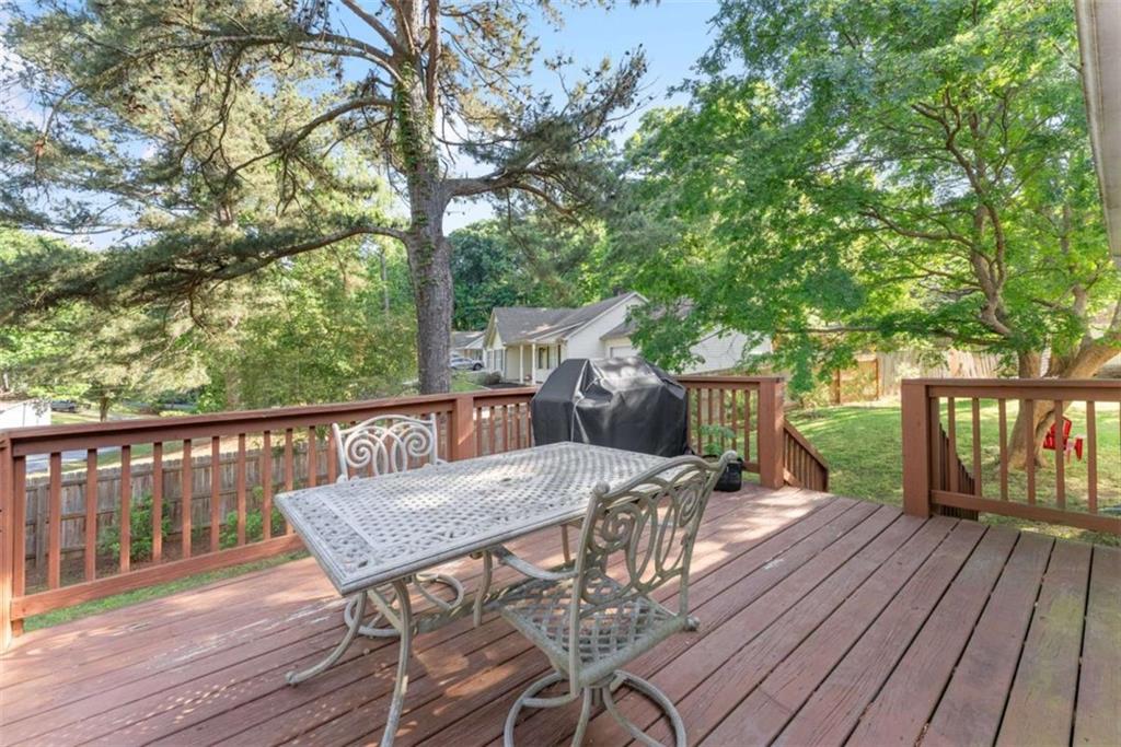 7210 Fields Drive Cumming, GA 30041 - Photo 33 of 58 a view of a wooden chairs and table on the wooden deck