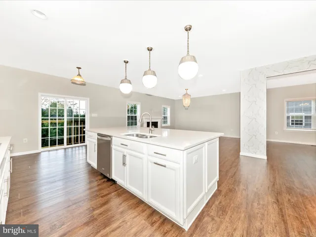 an empty room with window and ceiling fan