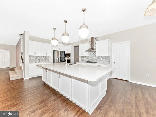 a bathroom with a granite countertop sink mirror and bathtub