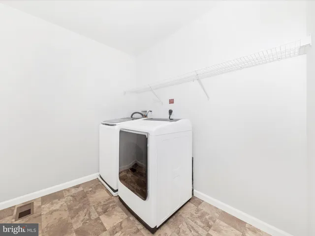 an empty room with windows and ceiling fan