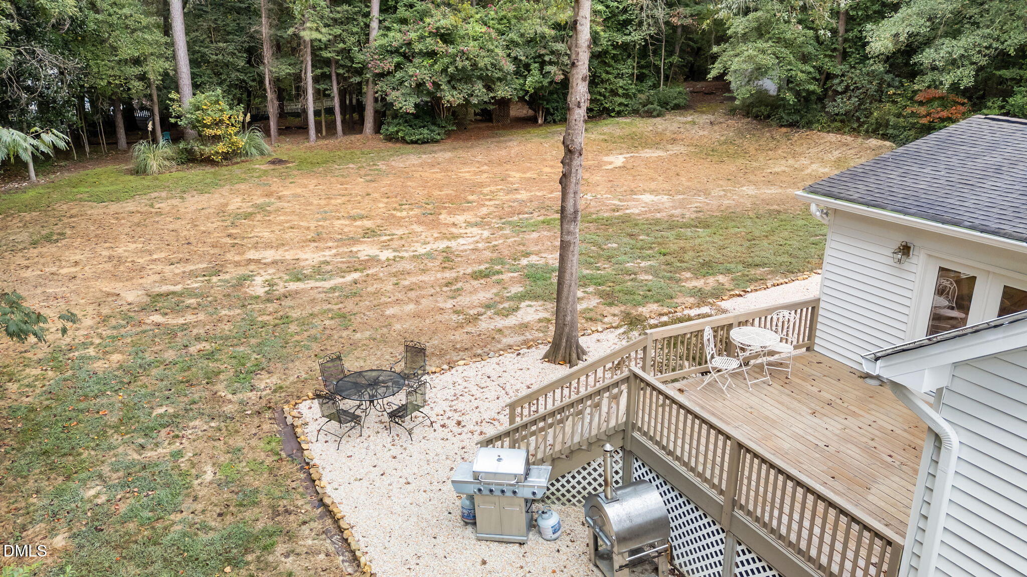 623 Canady Court Willow Spring, NC 27592 - Photo 13 of 42 a view of a patio with a table chairs and wooden fence