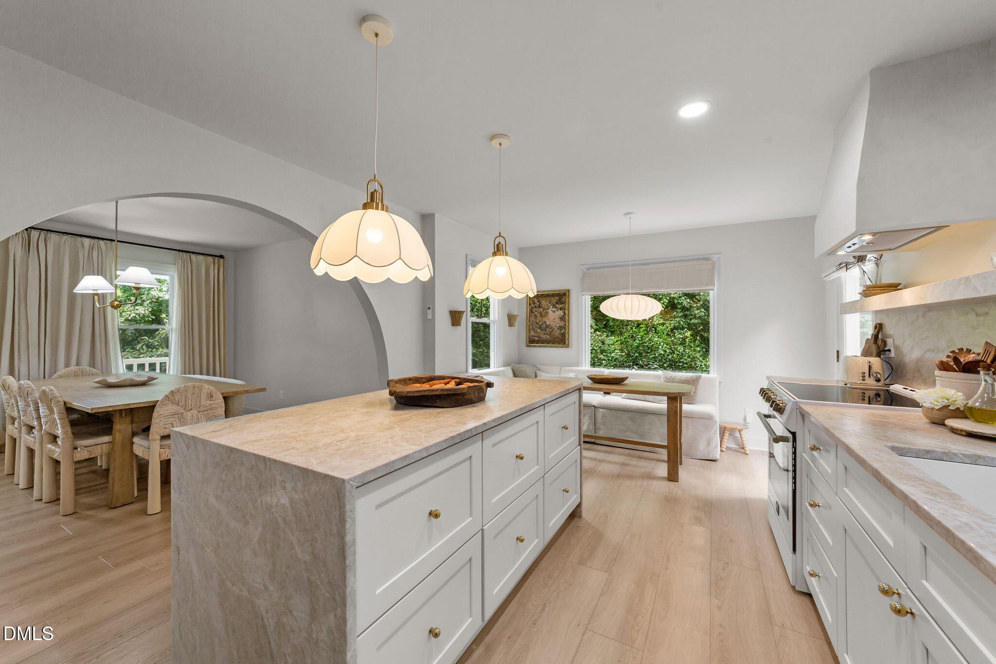 623 Canady Court Willow Spring, NC 27592 - Photo 26 of 42 a kitchen with a stove a sink a dining table and chairs