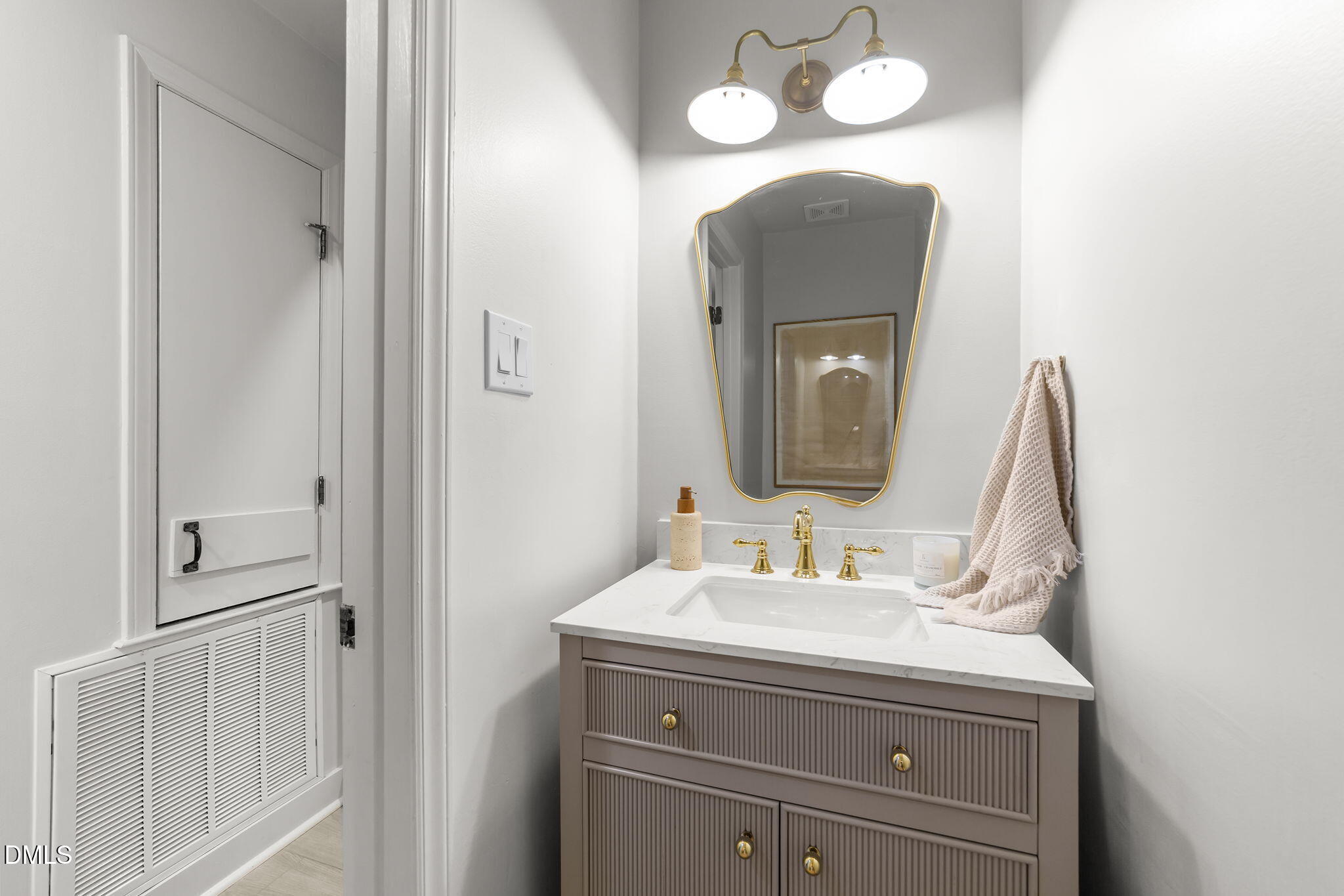 623 Canady Court Willow Spring, NC 27592 - Photo 30 of 42 a bathroom with a sink and a mirror