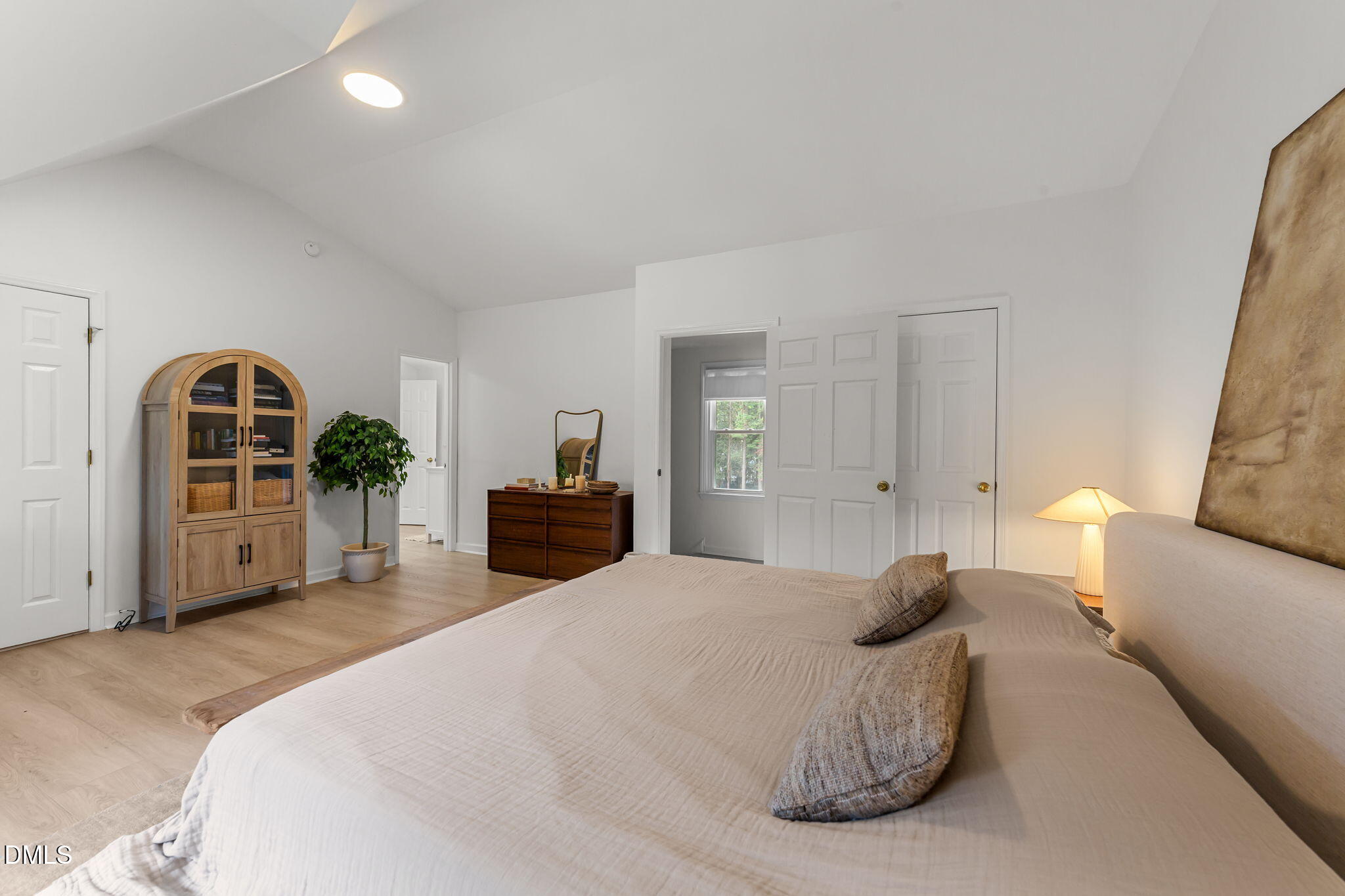 623 Canady Court Willow Spring, NC 27592 - Photo 32 of 42 a spacious bedroom with a bed a mirror and dresser