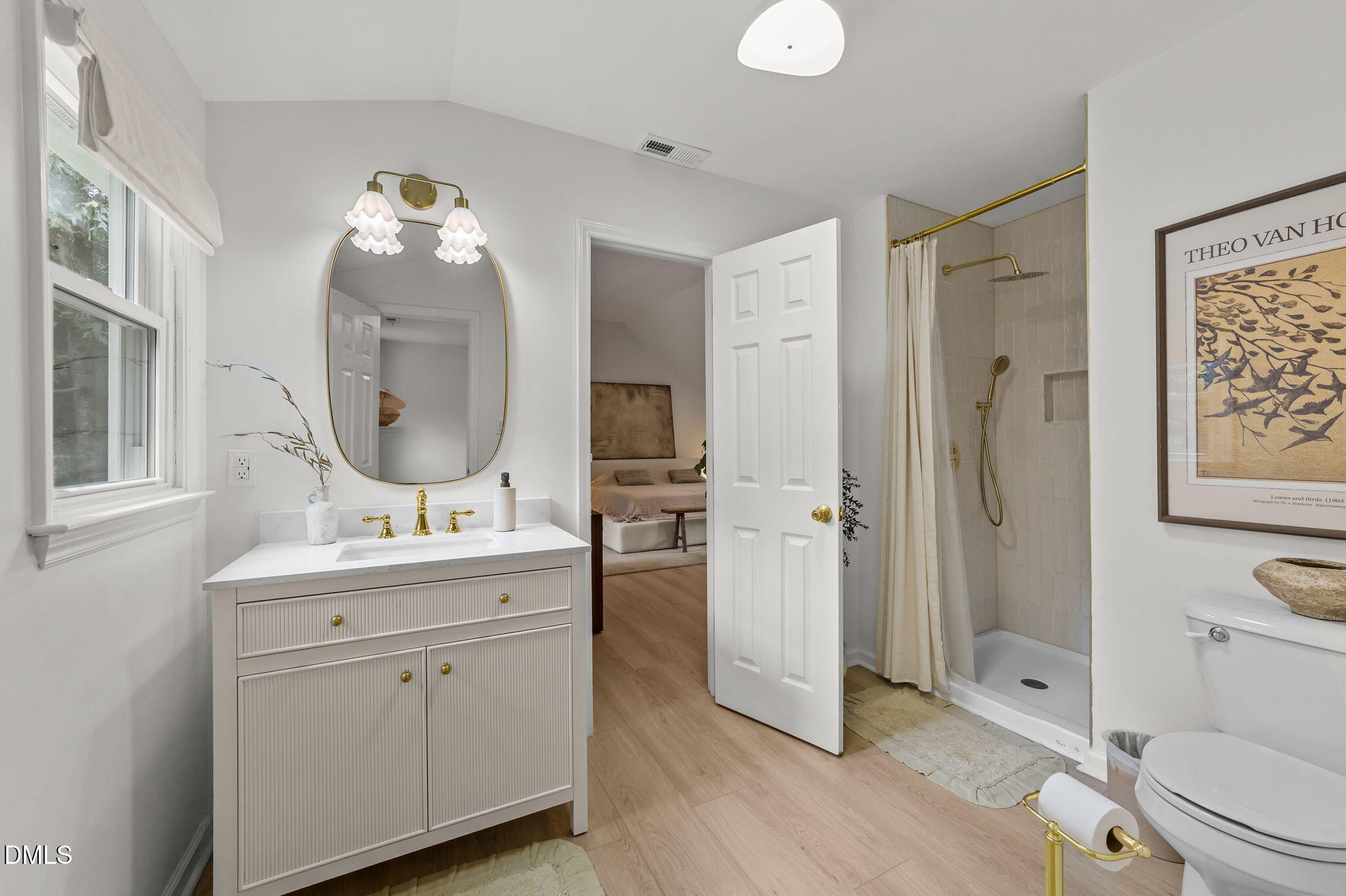 623 Canady Court Willow Spring, NC 27592 - Photo 34 of 42 a spacious bathroom with a toilet a sink and a mirror