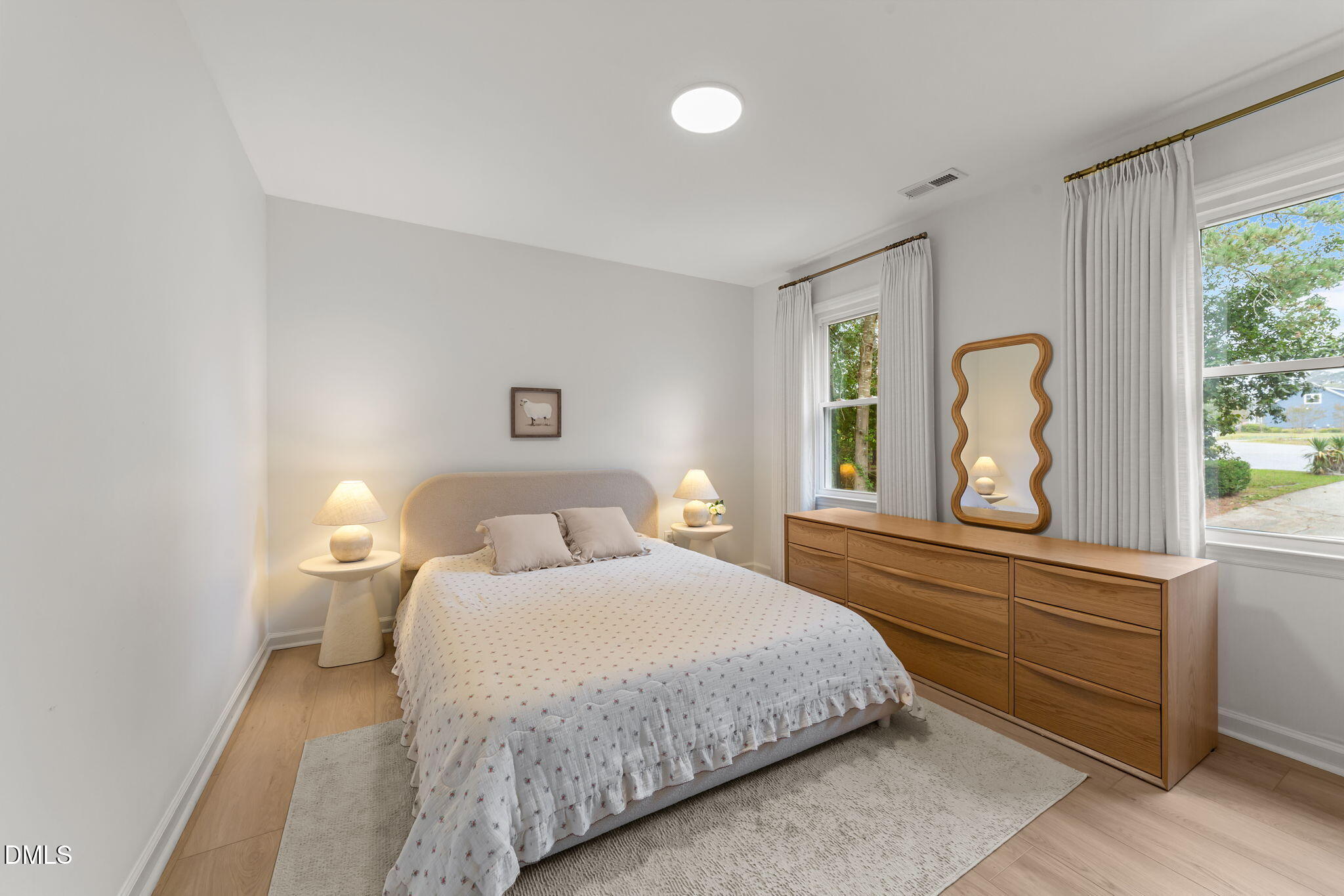 623 Canady Court Willow Spring, NC 27592 - Photo 36 of 42 a bedroom with a large bed and a large window