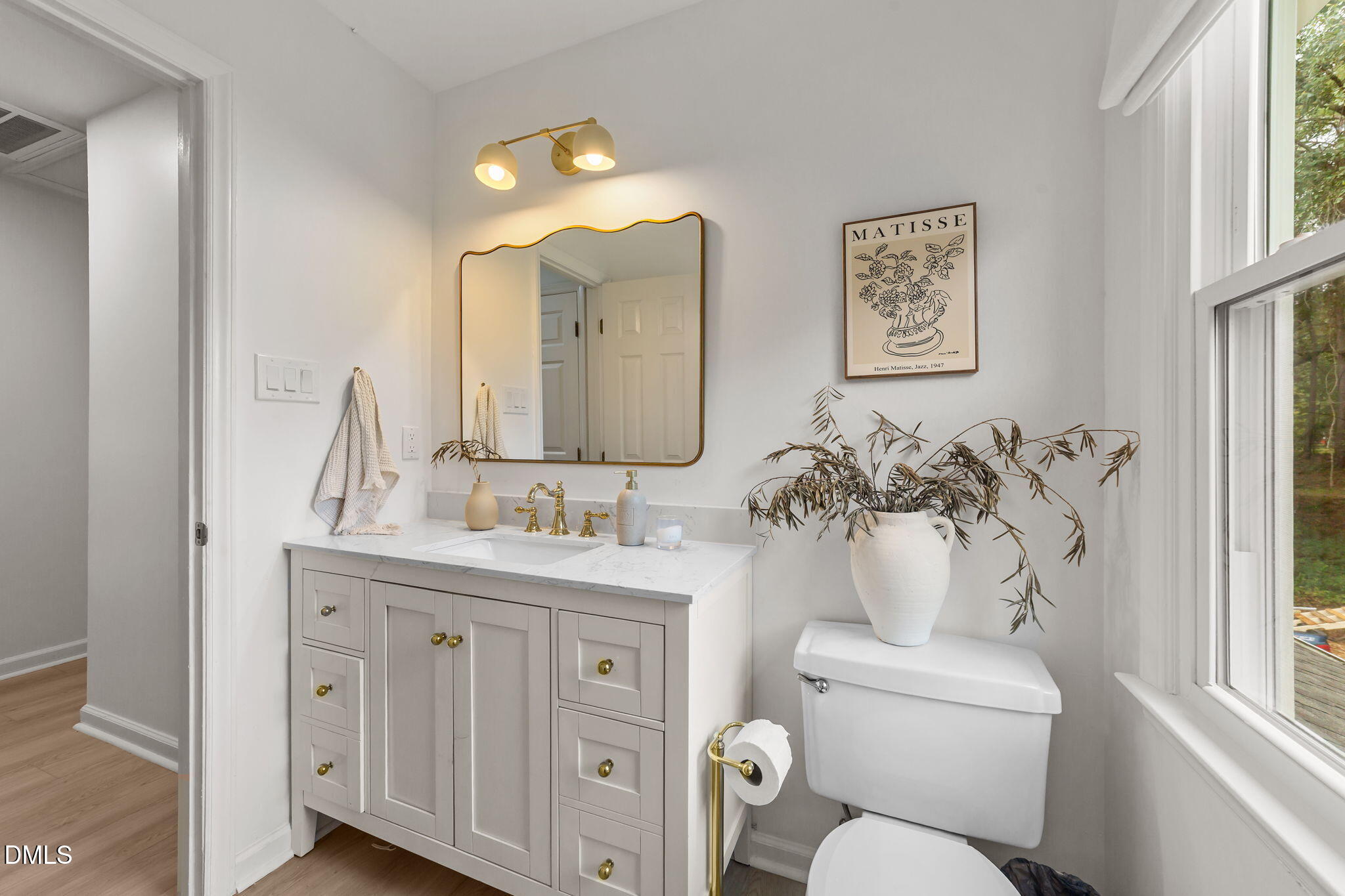 623 Canady Court Willow Spring, NC 27592 - Photo 37 of 42 a bathroom with a toilet sink and mirror