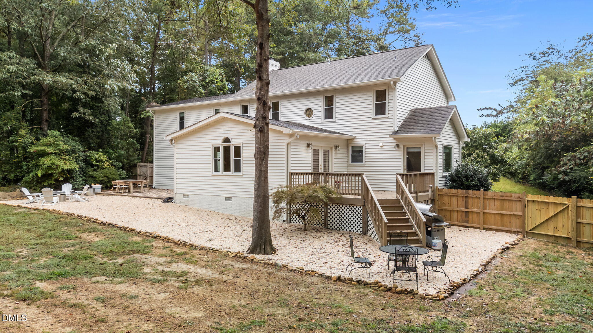 623 Canady Court Willow Spring, NC 27592 - Photo 6 of 42 a view of a white house with a yard and lawn chairs