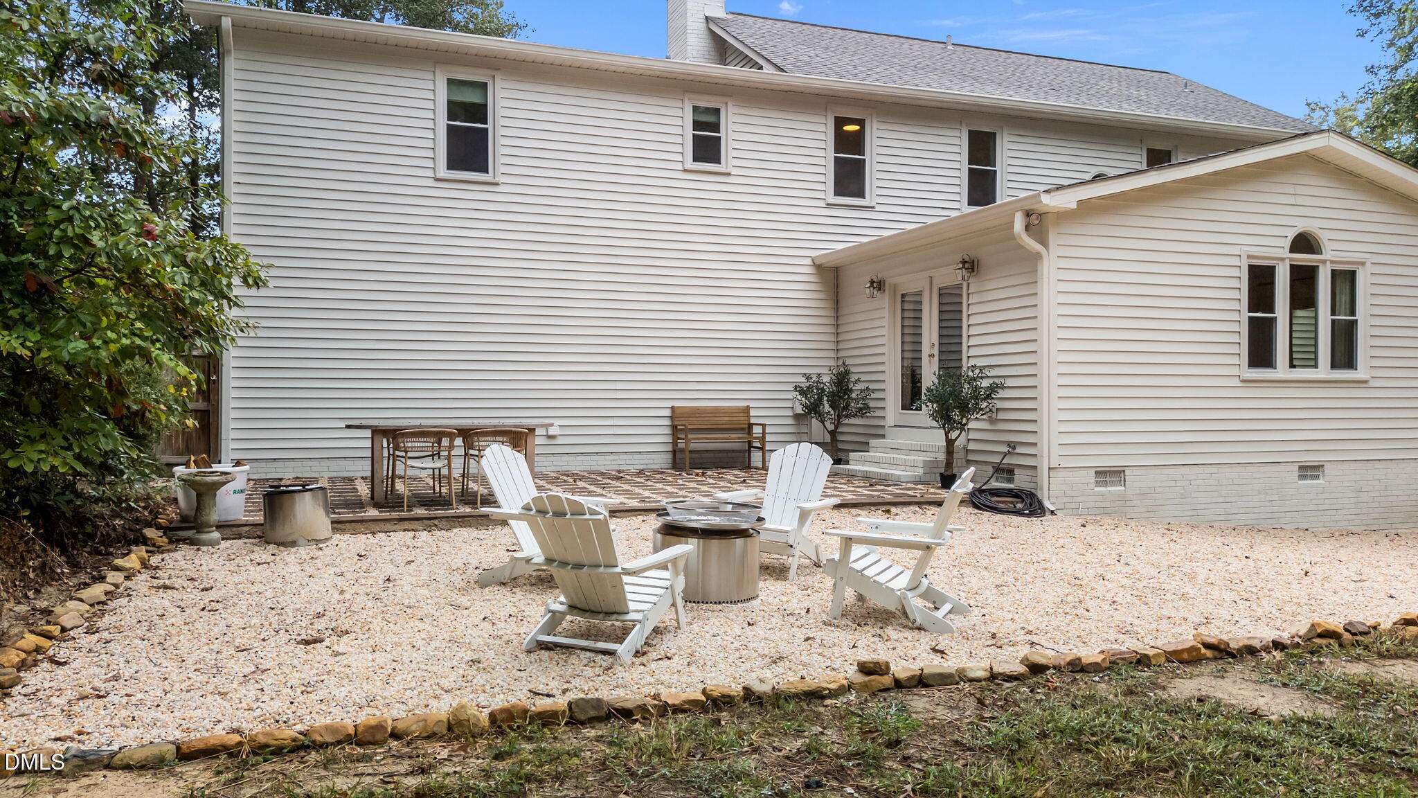 623 Canady Court Willow Spring, NC 27592 - Photo 8 of 42 a view of a dinning table and chairs in the back yard