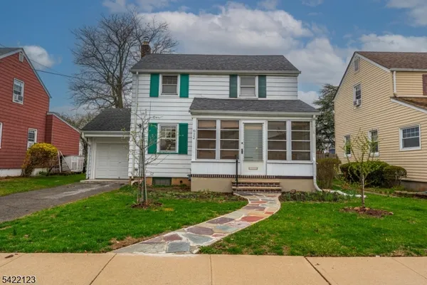 a front view of a house with a yard and outdoor seating