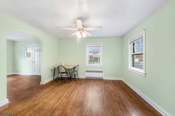 a hallway with a couch and chandelier