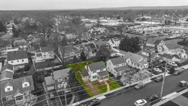 an aerial view of residential house with outdoor space and swimming pool