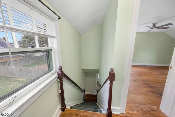 a view of a room with wooden floor