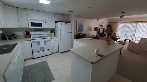 a kitchen with a sink a stove and refrigerator