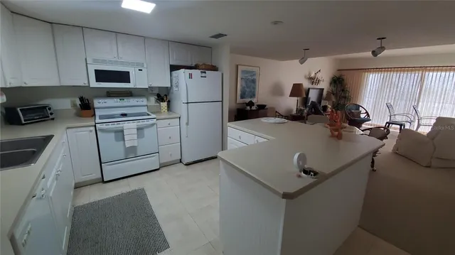 a kitchen with a sink a stove and refrigerator
