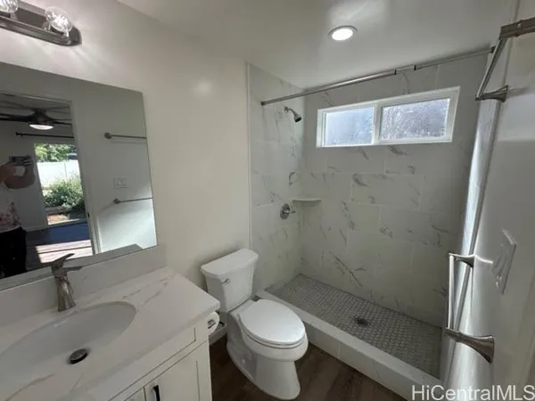 a bathroom with a sink toilet and shower