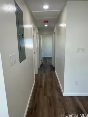 a view of hallway with wooden floor
