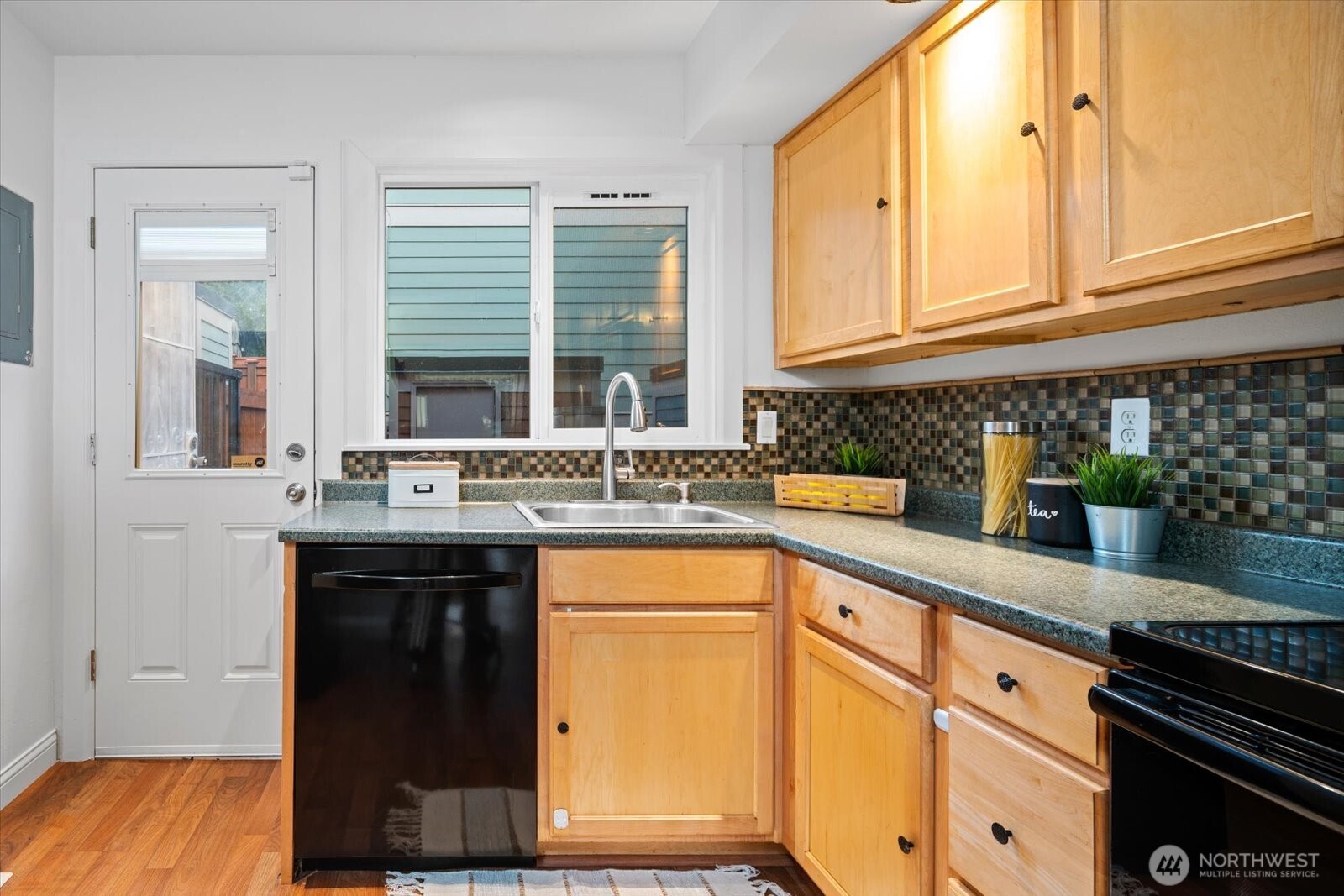 1600 Way E Yeslelr Way East, Unit 102 Seattle, WA 98122 - Photo 11 of 30 a kitchen with stainless steel appliances granite countertop a sink and a stove next to a window