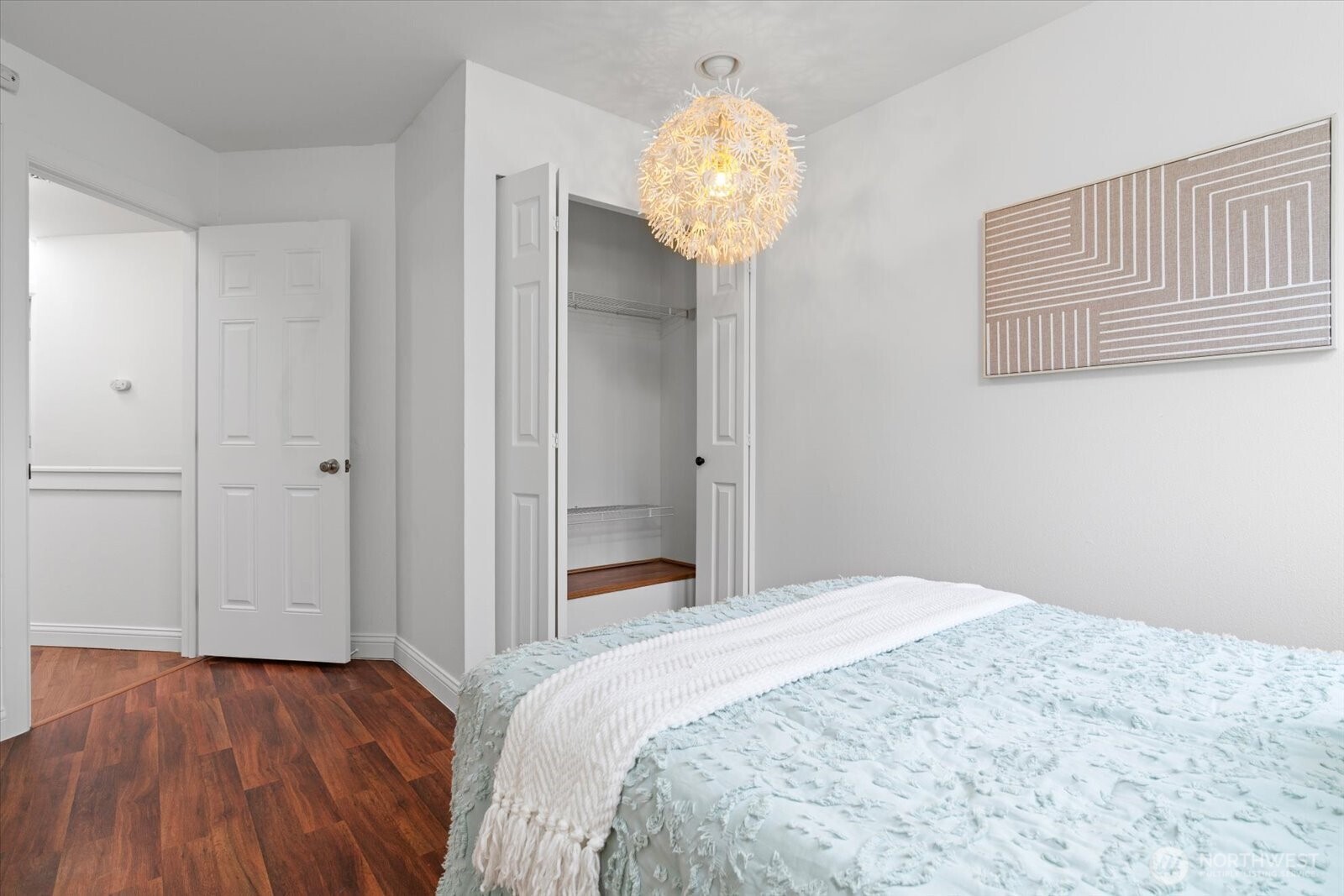 1600 Way E Yeslelr Way East, Unit 102 Seattle, WA 98122 - Photo 20 of 30 a bedroom with a bed and a chandelier