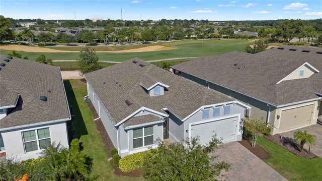 a kitchen with stainless steel appliances granite countertop a table chairs cabinets and wooden floor
