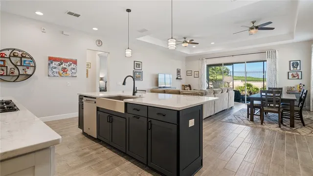 a kitchen with stainless steel appliances kitchen island granite countertop a refrigerator and a sink