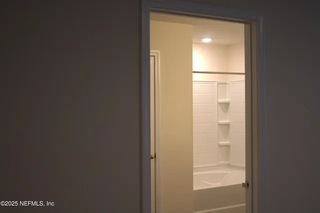 a bathroom with a glass shower door