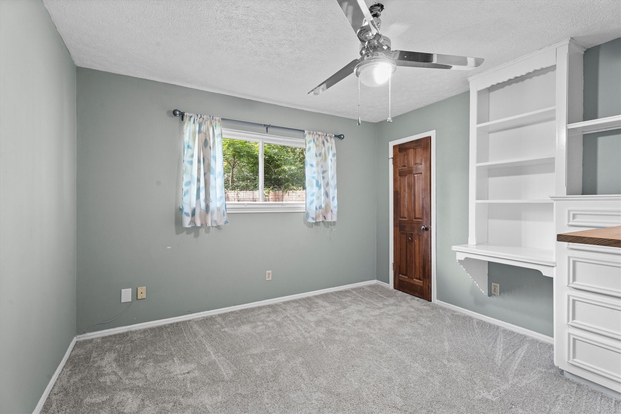 25319 Old Carriage Lane Spring, TX 77373 - Photo 25 of 35 a view of an empty room with a window and kitchen view