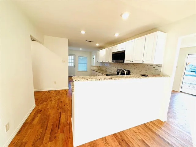 a kitchen with a stove a sink and a refrigerator