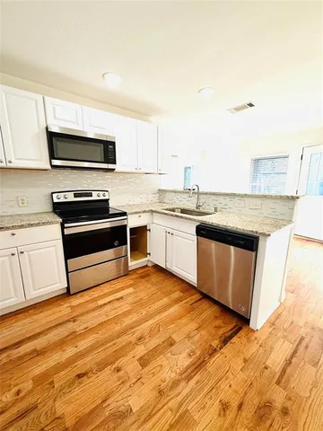 a spacious bathroom with a sink and a mirror