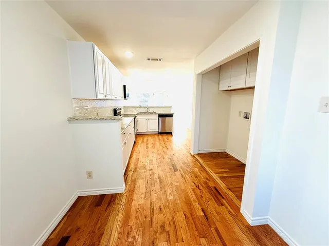 a kitchen with granite countertop a sink and a stove top oven