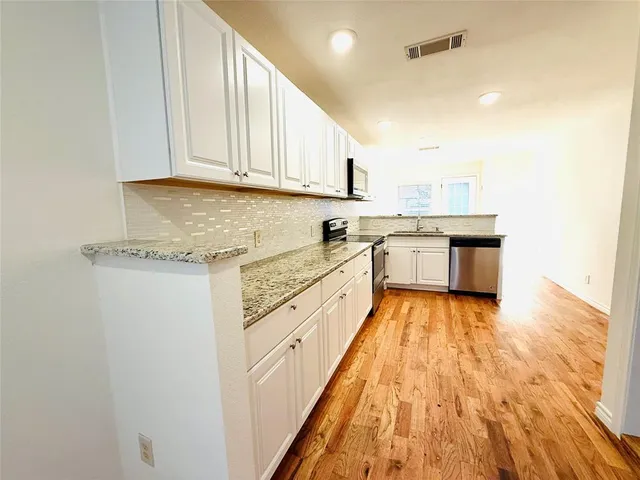 a view of an empty room and wooden floor