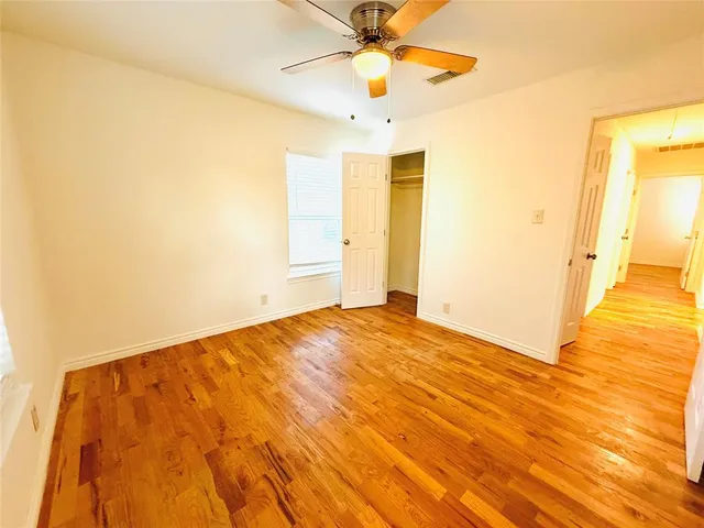 a view of a room with wooden floor and door